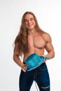 Singer bodybuilder shirtless with long hair in a blue hat with a microphone