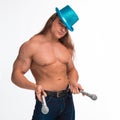 Singer bodybuilder shirtless with long hair in a blue hat with a microphone