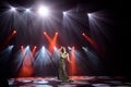 Singer in a dress on stage in the rays of bright light with smoke. Royalty Free Stock Photo