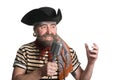 Singer dressed as pirate sings microphone.