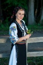 Singer with flowers in her hands posing at countryside Royalty Free Stock Photo