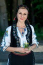 Singer with flowers in her hands posing at countryside Royalty Free Stock Photo