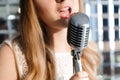 Singer in front of a microphone. Karaoke party. Beauty girl with a microphone singing. Disco party. Celebration.