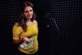 The singer next to the microphone and a pack of dollars in his hands. The skeptical look of a young woman who holds money Royalty Free Stock Photo