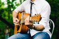 The singer plays an acoustic guitar and sings at a concert