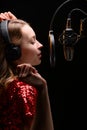 Singer or radio host blogger working in a professional studio. Recording a soundtrack, album, working with a label. Vertical photo