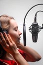 Singer or radio host working in a recording studio with a microphone in headphones close-up, blogging, radio, recording an album Royalty Free Stock Photo