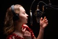 A singer or radio host is working in a recording studio with a microphone in headphones close-up, blogging, radio, recording an Royalty Free Stock Photo