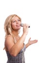 Singer. Young girl singing into microphone. Royalty Free Stock Photo