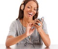 Singing along to my favourite songs. A happy ethnic woman with her headphones on and playing with her iphone. Royalty Free Stock Photo
