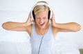 Singing along. A young woman listening to music on her headphones. Royalty Free Stock Photo
