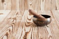 Singing bowl on wooden background. Burning candles and oil for aromatherapy and massage. Royalty Free Stock Photo