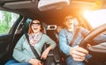 Cheerful young traditional family has a long auto journey and singing aloud the favorite song together. Safety riding car concept Royalty Free Stock Photo