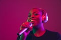 African-american young woman`s portrait on purple pink background