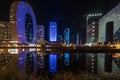 Singing light and music fountain on background of panorama of beautiful buildings at night Royalty Free Stock Photo