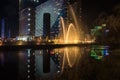 Singing light and music fountain on background of panorama of beautiful buildings at night Royalty Free Stock Photo