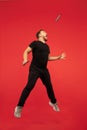 Full length portrait of young successfull high jumping man gesturing isolated on red studio background Royalty Free Stock Photo