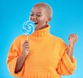 Singing, lollipop and a woman with candy in studio for sweets, rainbow and creative advertising. Happy black female