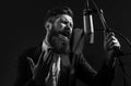 Singing man in a recording studio. Expressive bearded man with microphone. Karaoke signer, musical vocalist. Royalty Free Stock Photo