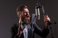 Singing man in a recording studio. Music festival. Expressive bearded man with microphone. Karaoke signer, musical Royalty Free Stock Photo