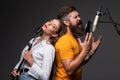 Singing man in a recording studio. Expressive couple with microphone. Karaoke duet signers, musical vocalist. Royalty Free Stock Photo