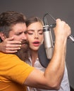 Singing man and woman in a recording studio. Sensual couple with microphone. Karaoke signer, musical vocalist. Royalty Free Stock Photo