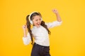 Singing in tune. Cute small child taking her singing lessons on yellow background. Adorable little girl singing her Royalty Free Stock Photo