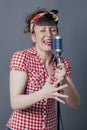 Singing young woman performing with retro micro