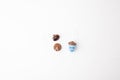 a single acorn with a white string loop attached to its cap, set against a white background. string suggests it could