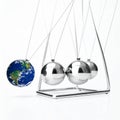 Global Impact - A Newtons Cradle with Planet Earth Royalty Free Stock Photo