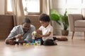 Black happy man playing with small cute son.