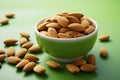 Single almond in a white ceramic bowl on green background, promoting healthy eating