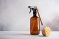 Single amber brown spray bottle and dish brush for cleaning Royalty Free Stock Photo