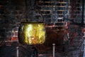 Single Antique vintage 1590 cauldron hand forged cooking pot hangged by the hearth fireplace old golden Royalty Free Stock Photo