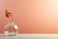 Single apple on branch in clear vase against peach background