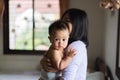 Single asian mother carrying baby cute boy in bedroom,Mother`s day concept