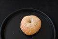 A Single Bagel with Sesame on dark plate Royalty Free Stock Photo
