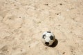 Single Ball on the beach with nobody. Broken classic ball on the sand.