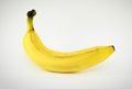 Single banana against white background Royalty Free Stock Photo