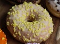 single banana donut with sprinkles on a wooden background Royalty Free Stock Photo