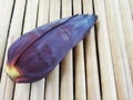 Single Banana Flower or Blossom on Bamboo Surface