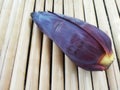 Single Banana Flower or Blossom on Bamboo Surface