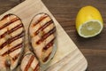 Single BBQ Grilled Salmon Steak On The Wood Board Royalty Free Stock Photo