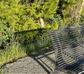 Single Bench. Bench Sits in the Sun, Lonely Bench in Summer. Shadow on the Vegetation from the Bench