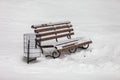 Single bench covered with snow in winter park Royalty Free Stock Photo