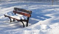 Single bench covered with snow in winter park Royalty Free Stock Photo