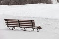 Single bench covered with snow in winter park Royalty Free Stock Photo