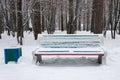 Bench covered snow in winter park. Royalty Free Stock Photo