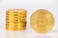 Single Bitcoin coin standing on top of other gold coins. Royalty Free Stock Photo