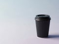 Single black coffee cup with lid on a plain background Royalty Free Stock Photo
